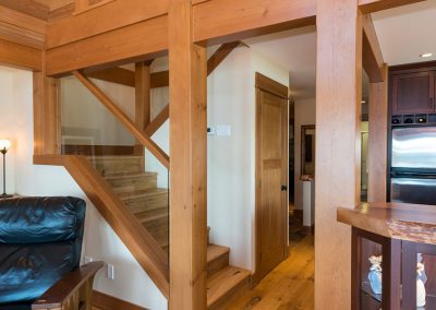custom home interior stairwell with timber framing