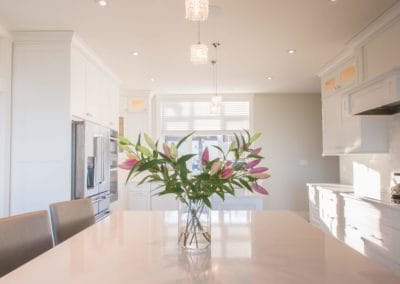 Flowers on one of two islands in kitchen of home