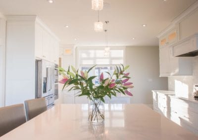 Flowers on one of two islands in kitchen of home