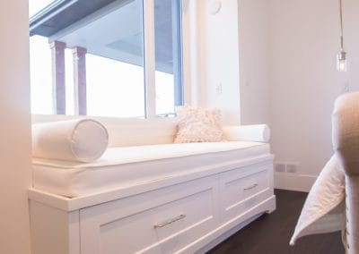 White window seat with cushions in custom home