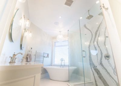 Full view of bright white custom bathroom with standing tub, shower with rain head goldstream heights custom home