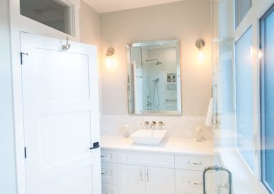 Bright white bathroom with glass, chrome fixtures