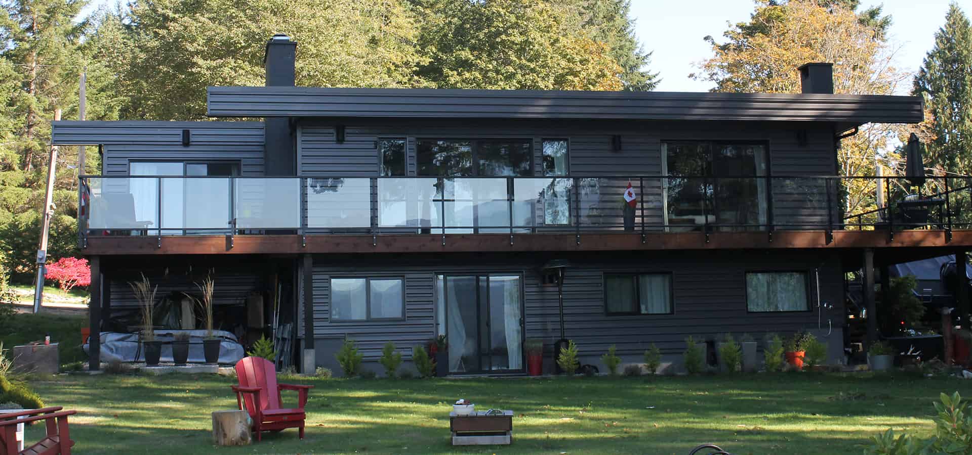 Unique metal siding on our mid-century modern Yellowpoint renovation with custom glass railings.