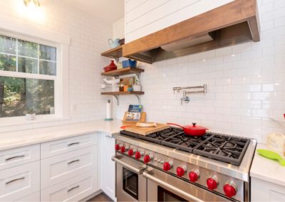 Shiplap hood vent and wolf gas range in custom home