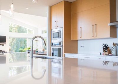 Bare Point custom home kitchen island natural wood cabinets