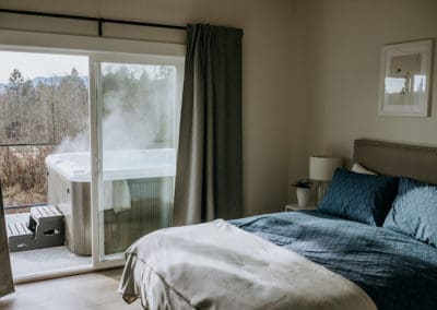 bedroom with sliding door to deck custom home