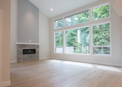 view of living room from kitchen with natural wood floors