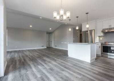 Dining room, kitchen and living room with vaulted ceiling