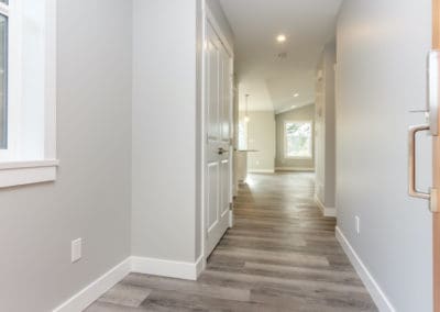 Hallway with hall closet leading to main living area