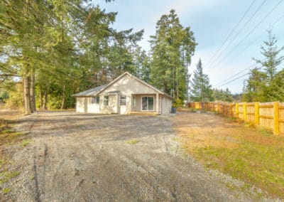 Rear exterior of home covered back deck