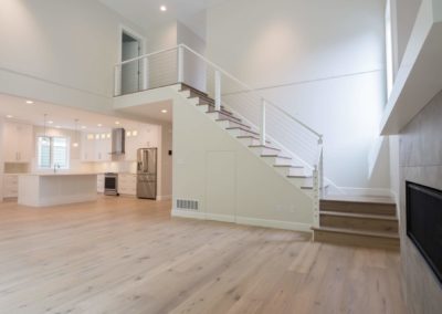 staircase and kitchen driftwood custom home