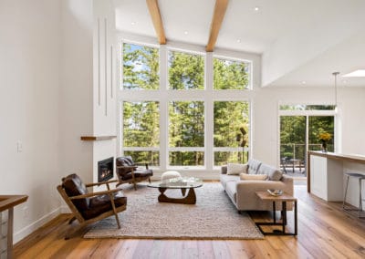 Vaulted ceilings and many windows in custom home living room