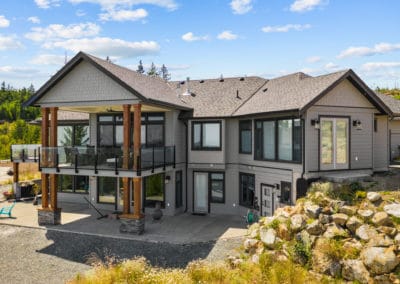 goldstream heights custom Home exterior from rear with large deck and patio