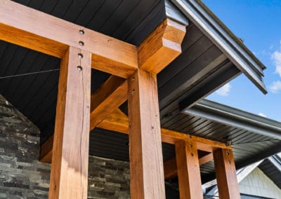 close up detailing of timber framing front entry exterior goldstream heights custom home