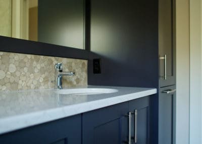 dark custom cabinets and inset sink in bathroom
