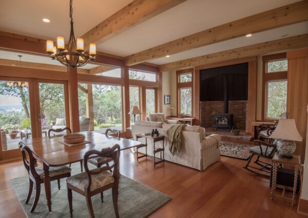 Open concept living room with wood burning brick surround fireplace
