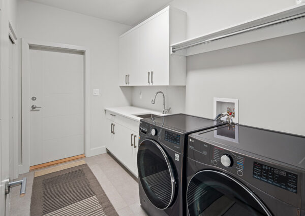 Laundry room in modern lakefront home