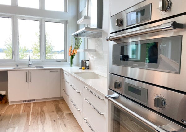 stainless steel appliances and lake views from modern kitchen