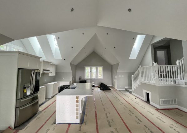 great room with vaulted ceilings and skylights in carriage home