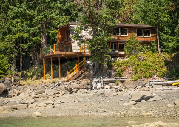 A-frame exterior surrounded by mature trees on Thetis Island