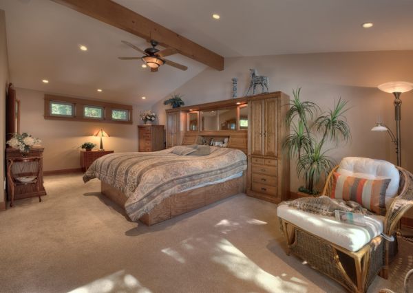 Primary loft bedroom with vaulted wood ceiling