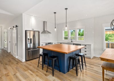 Marble Bay Lake house kitchen blue island wood counter