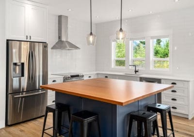 Wood counter and blue cabinets kitchen island