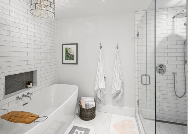 Freestanding tub with chandelier and walk-in glass shower