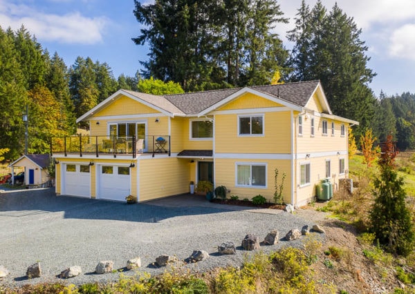 Yellow modern farmhouse front exterior from side