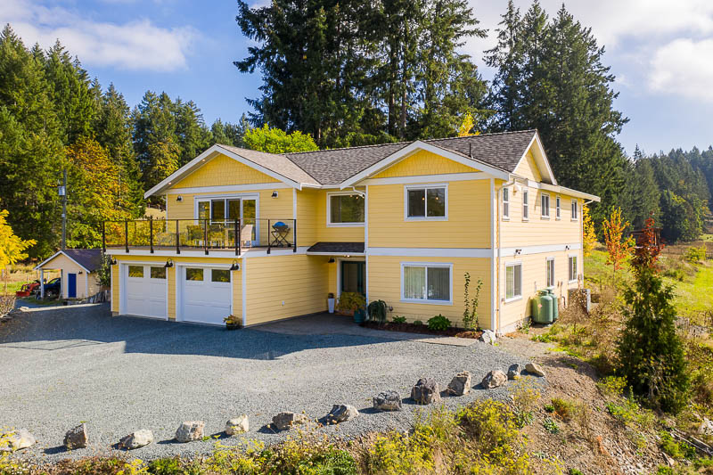 Yellow modern farmhouse front exterior from side