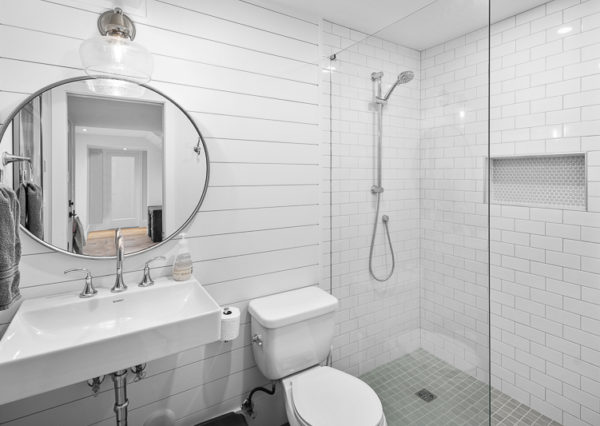 White three piece bathroom with walk-in tiled shower