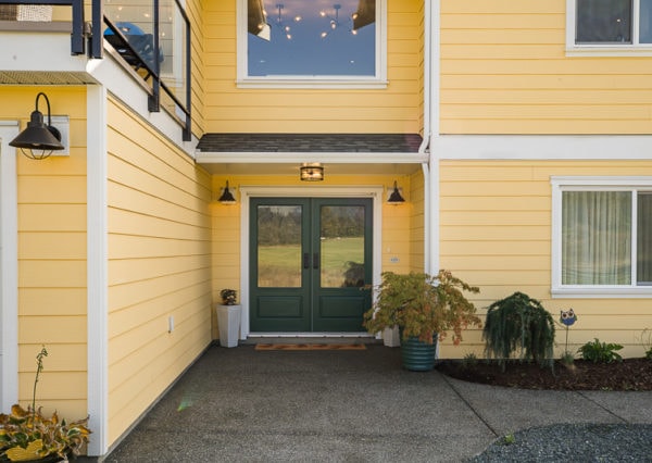Green front door, yellow house