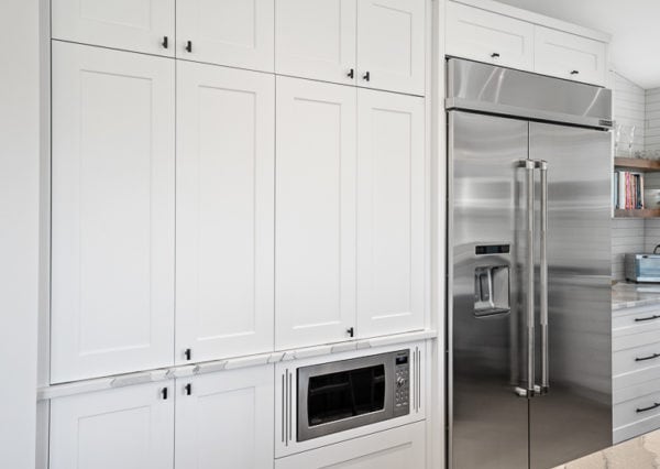 Custom white shaker cabinetry with black hardware