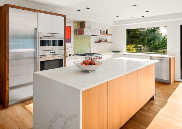 Waterfall kitchen island in modern 80s revival renovation