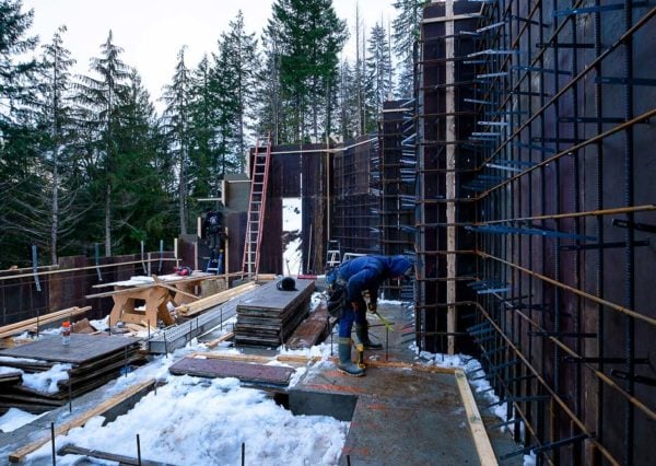 Construction worker inspecting foundation