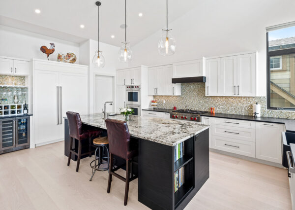 Kitchen white cabinetry and multi-coloured tile backsplash