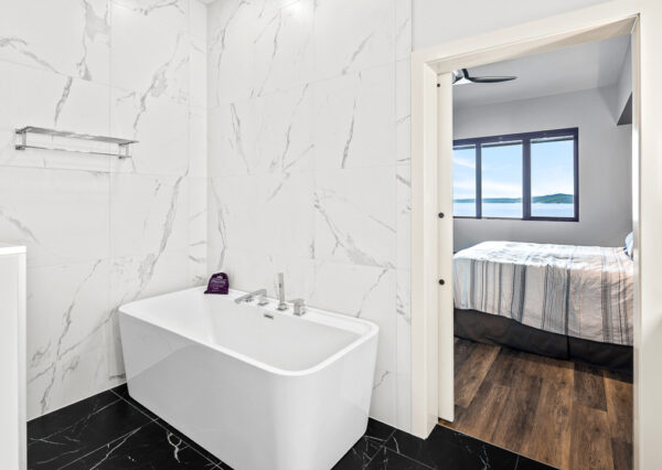 Freestanding tub master bathroom black tile, tile walls