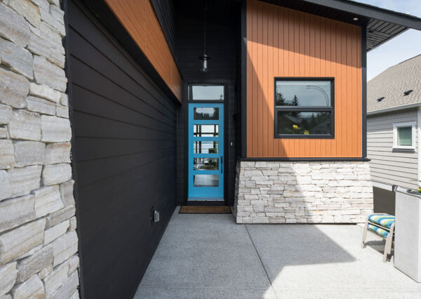 Modern custom home exterior with blue front door