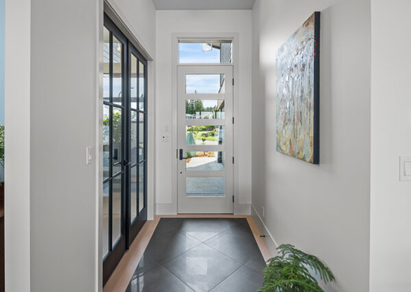 Tile and hardwood front entryway with glass front door