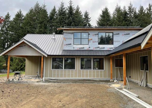 metal roof, windows in on custom home construction