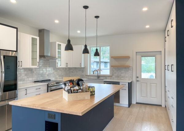 Pendant lights over island in lakefront kitchen