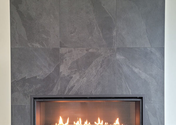 Gas fireplace dark gray tile floor to ceiling