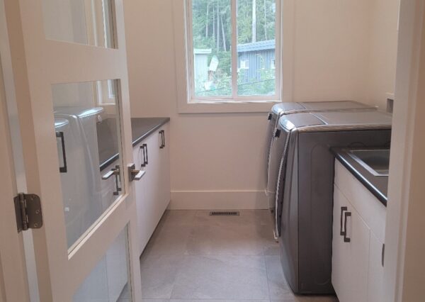 Light gray tile floor laundry room