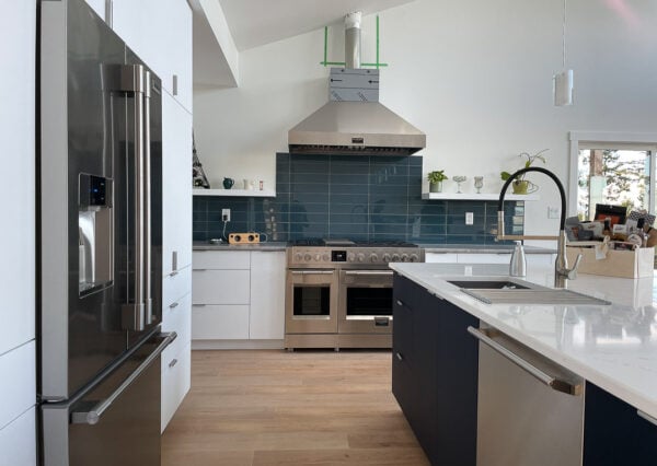 Blue backsplash and white cabinetry in Malahat Modern kitchen
