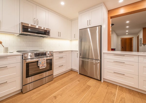 white cabinetry stainless steel appliances