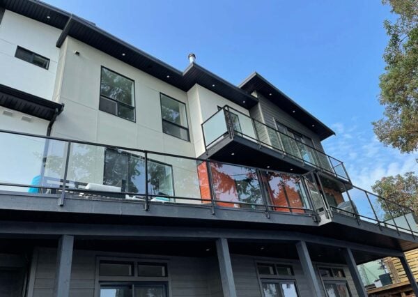 two levels of decking with glass railing home exterior