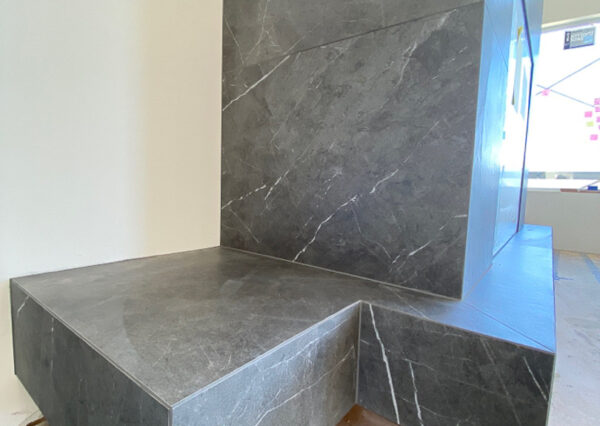 Gray stone tile fireplacxe surround custom home