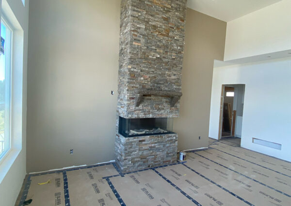 Rustic rock fireplace surround with glass gas insert