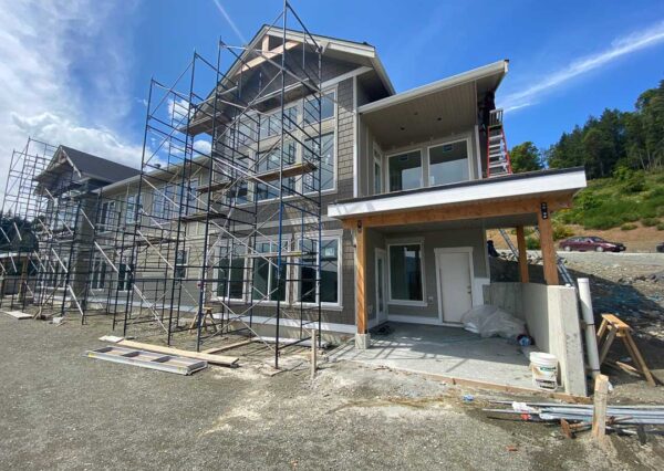 Under construction duplex with primed siding in progress