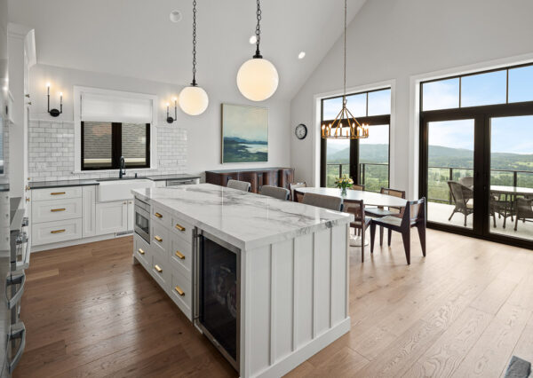 island with white cabinetry and gold hardware, stainless steel appliances